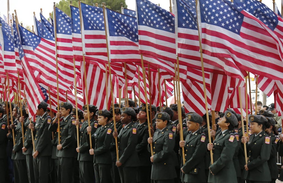 From Dallas GuideLive: Dallas area ROTC squads hold dozens of American flags in formation as they kick off the festivities on Veterans Day in 2014. 